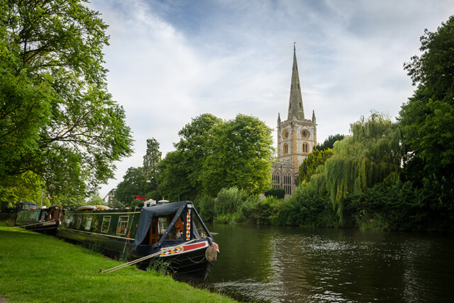 Boat on the banks of the River Avon, with a view of Holy Trinity Church, Stratford-Upon-Avon