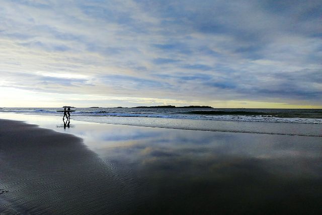 Surfers heading out to sea