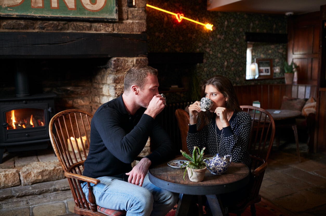 Couple drinking tea in cosy pub