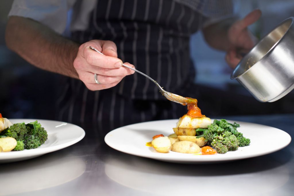 chef plating up seafood dish (1)