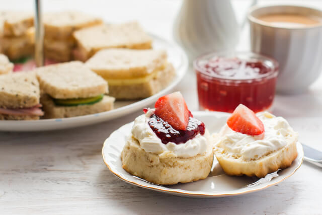 finger sandwiches and scones with cream and jam