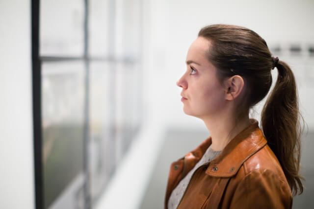 girl looking at art in museum