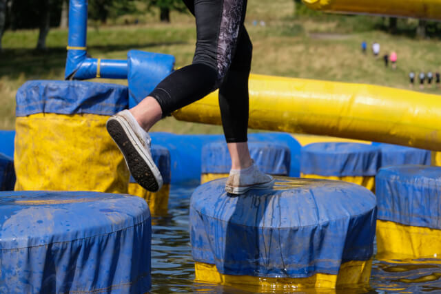 person on inflatable aqua obstacle course