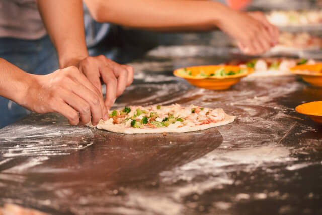 pizzas being made