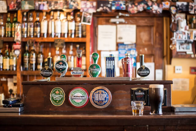 range of beer taps at pub bar